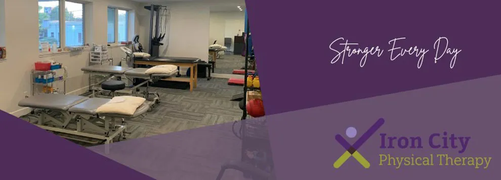 Inside the clinic: treatment tables, exercise equipment and a cable machine