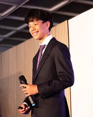 Ethan Wong speaking on stage
